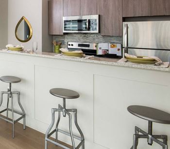 Modern kitchens with granite countertops, stainless steel appliances, under-mounted sinks, and breakfast bar